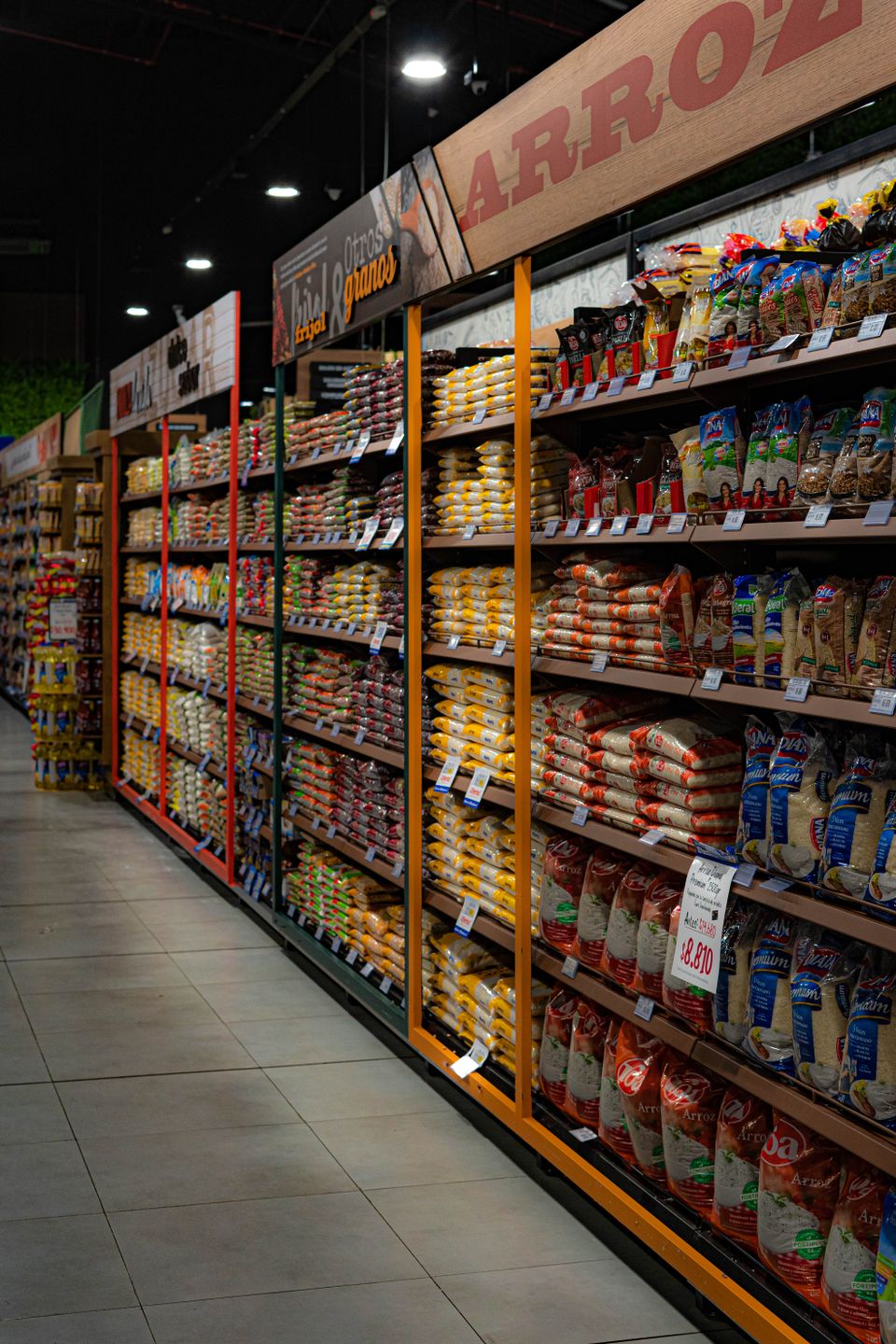 Shelves stocked with packaged rice and dry groceries