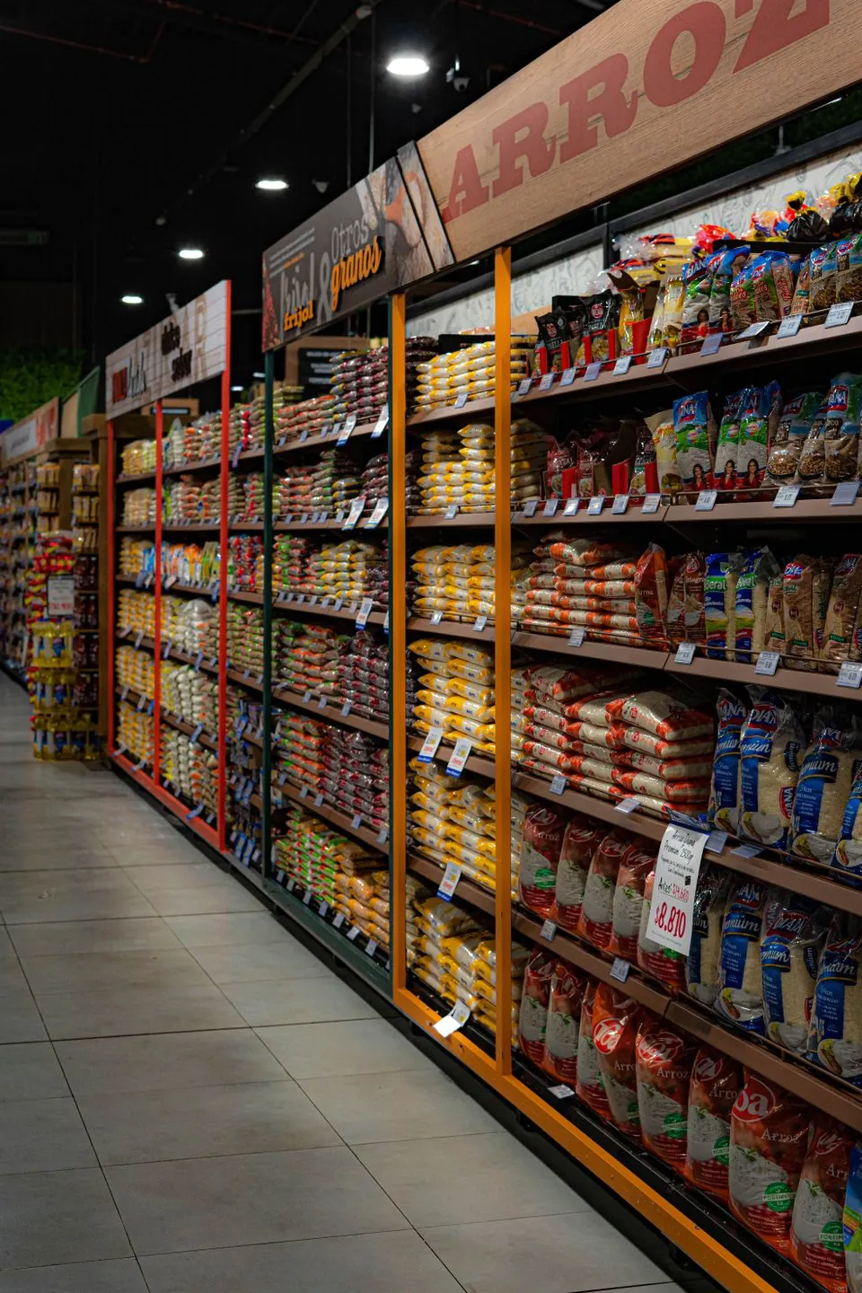 Shelves stocked with packaged rice and dry groceries